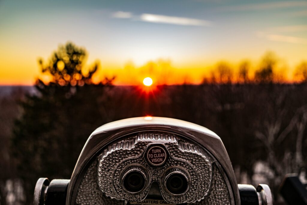 selective focus photo of silver tower viewer telescope facing sunshine