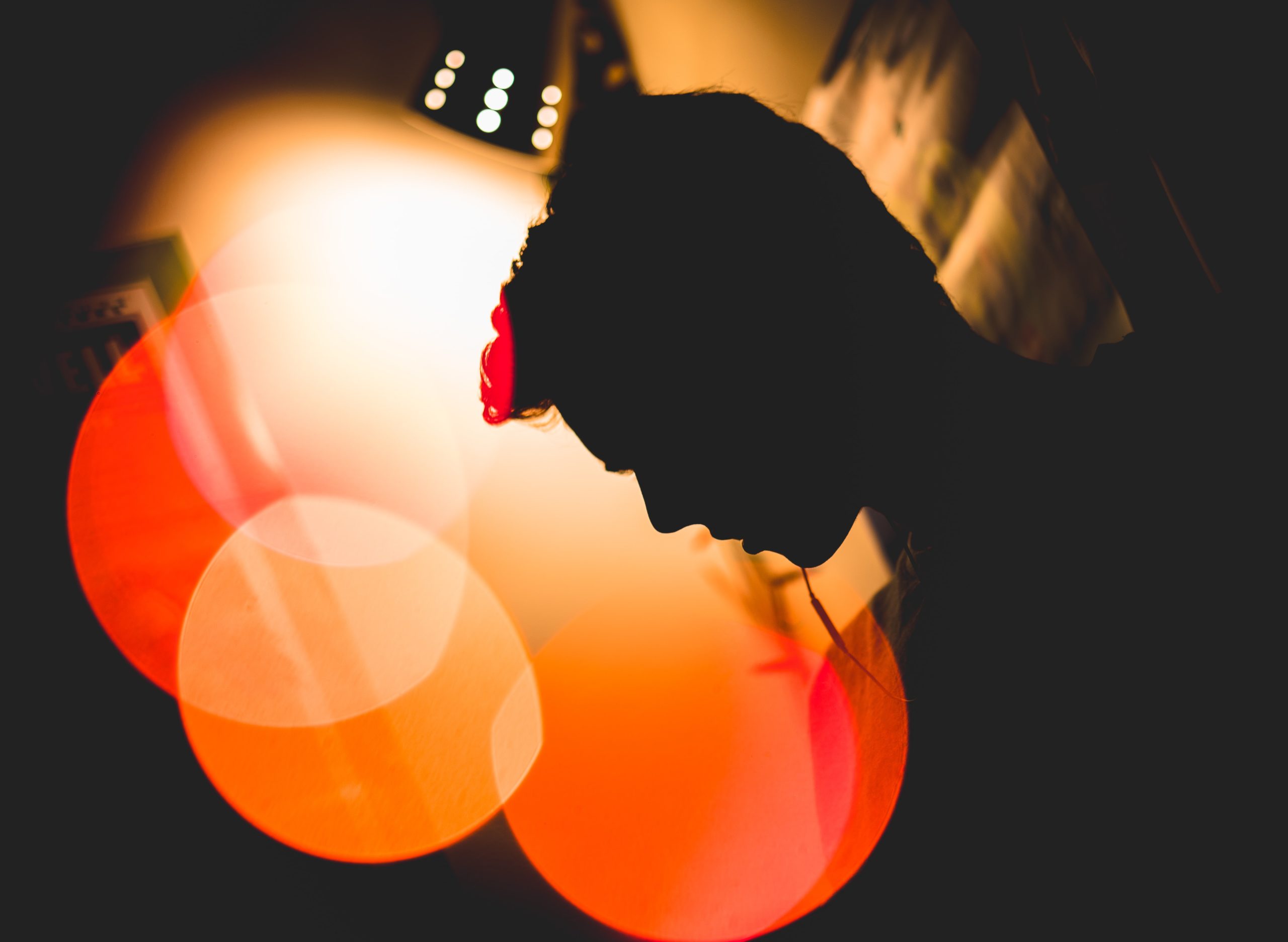 This is one of my favorite portraits ever. I was bored, and decided to play around with some Christmas lights that had recently made their way onto our walls. I took some off, played around with them, and viola! A beautiful circle of three lights playing to the mysterious shadows of my friend. It’s a super intense and abstract shot, but with great results.